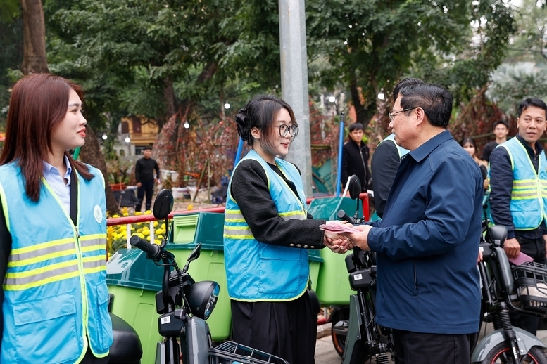 Thủ tướng thăm và động viên công nhân môi trường đô thị đang thực hiện nhiệm vụ tại phố Trần Nhân Tông - Ảnh: VGP/Nhật Bắc